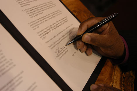 Bishop Eben K. Nhiwatiwa of the church's Zimbabwe Area signs a covenant to extend through 2012 the partnership between the Zimbabwe and Baltimore-Washington conferences. The signing ceremony occurred April 30 during the 2008 United Methodist General Conference. 