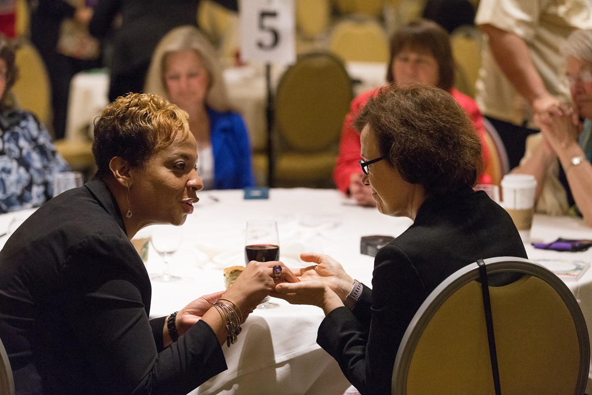 United Methodist Bishop Tracy Smith Malone (left) offers Holy Communion to Bishop Debra Wallace-Padgett during the closing worship service at the denomination's Council of Bishops meeting in Chicago. The bishops asked the Judicial Council to hold an oral hearing on their request for a declaratory decision of law about what legislation can come before the special session of General Conference. Photo by Mike DuBose, UMNS
