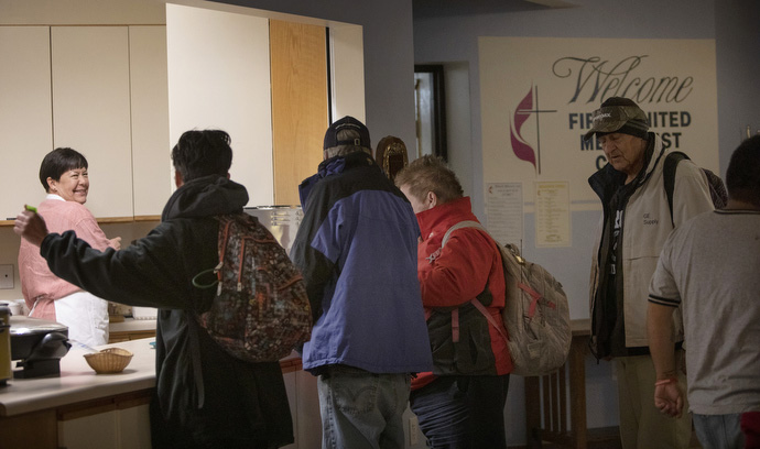 Sunday morning breakfast feeds 50 homeless at First United Methodist Church in Salt Lake City where church volunteers and homeless share community. 