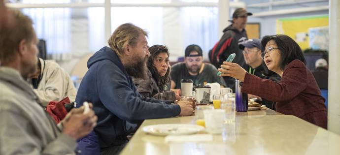 The Rev. Elizabeth McVicker visits with guests at the Sunday Fellowship Breakfast at First United Methodist Church in Salt Lake City. She is in conversation with Rachel Ramos and Larry Neilson.  