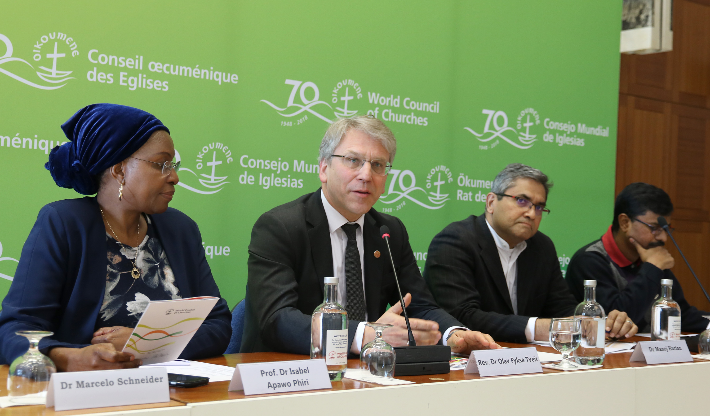 Staff at the World Council of Churches speak during a public launch in Geneva for a new downloadable resource to help churches take practical steps to care for the earth. The event also honored the legacy of the Rev. Norman Tendis, who died in the Ethiopian Airlines crash two days earlier. From left are Isabel Apawo Phiri, the Rev. Olav Fykse Tveit,  Dr. Manoj Kurian and Dinesh Suna. Photo by Ivars Kupcis/WCC.