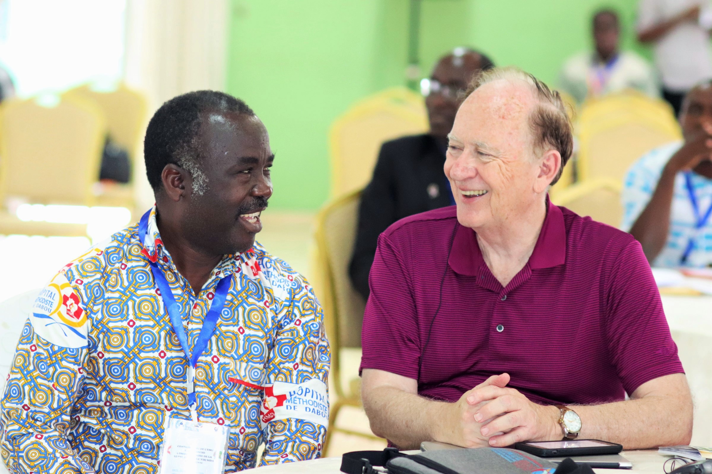 Le Dr Daniel Ahui (à gauche), directeur de l'Hôpital Méthodiste Uni de Dabou, et le Révérend Donald Messer, directeur exécutif de Center for Health and Hope, s’entretiennent pendant le sommet. L'hôpital de Dabou fournit des soins à 1 362 patients atteints du VIH. Photo de Isaac Broune, UMNS.