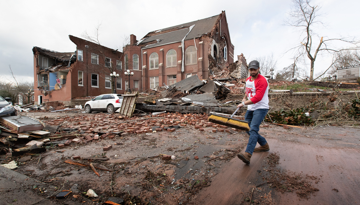 Volunteer Sumant Joshi clears tornado debris in front of East End United Methodist Church in Nashville, Tenn. Photo by Mike DuBose, UM News.
