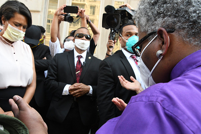 United Methodist Bishop LaTrelle Easterling (right) offers a prayer during an interfaith vigil near the White House on June 3. Washington Mayor Muriel Bowser (left) joined the prayer vigil. Photo by Melissa Lauber, Baltimore-Washington Conference.