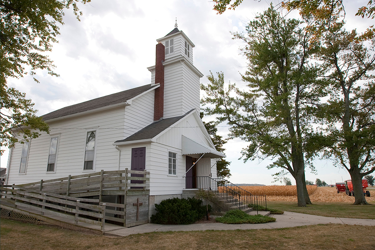 Corn is harvested from a field next to New Hope Bethel United Methodist Church outside Leipsic, Ohio, in 2010. Allen T. Stanton, author of “Reclaiming Rural: Building Thriving Rural Congregations,” suggests the church can be a leader in economic and community development. File photo by Mike DuBose, UM News.