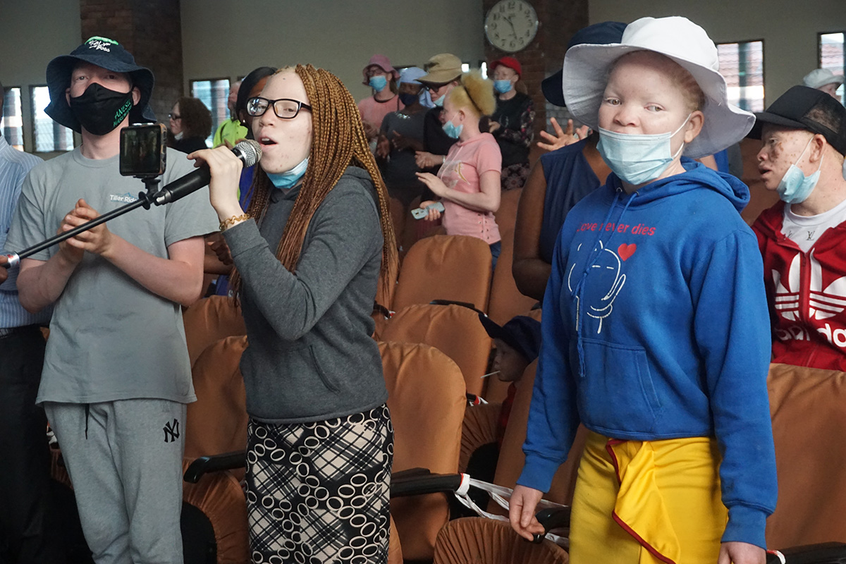 Tapiwanashe Nhunhama helps lead worship at Cranborne United Methodist Church in Harare, Zimbabwe, during a program to help support people living with albinism. The United Methodist Church’s Harare East District in partnership with the Johnstown District in the Western Pennsylvania Conference gave gifts of sunscreen, hats and food to people living with the condition. Photo by Kudzai Chingwe, UM News.
