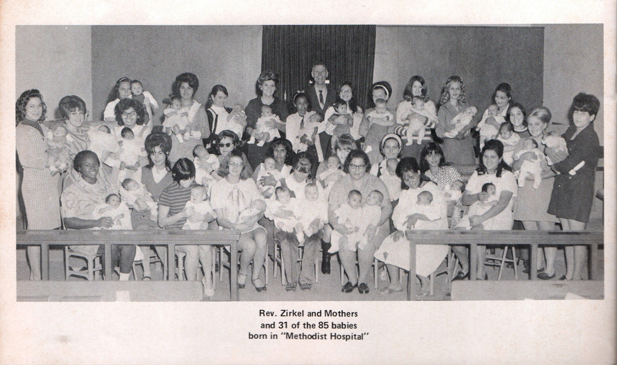 First United Methodist Church of Aransas Pass, Texas, became a temporary hospital after Hurricane Celia clobbered the community on Aug. 3, 1970, and 85 or 86 babies (accounts vary) were born in the church’s education wing. Moms with 31 of those babies gathered for a photograph, as did the church’s pastor, the Rev. Milford “Zeke” Zirkel, who is standing at back. Photo courtesy First United Methodist Church of Aransas Pass.