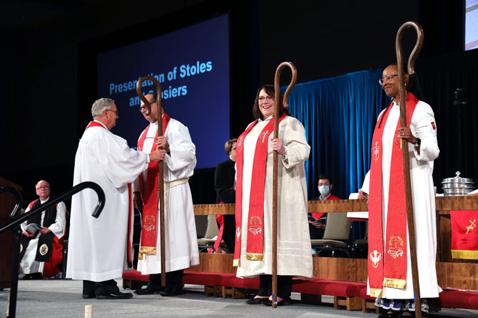 Bishop Bruce Ough (left) presents crosiers to newly elected Bishops Dan Schwerin, Lanette Plambeck (center) and Kennetha Bigham-Tsai during the North Central Jurisdiction’s consecration service on Nov. 5 in Fort Wayne, Ind. Photo courtesy of the North Central Jurisdiction.