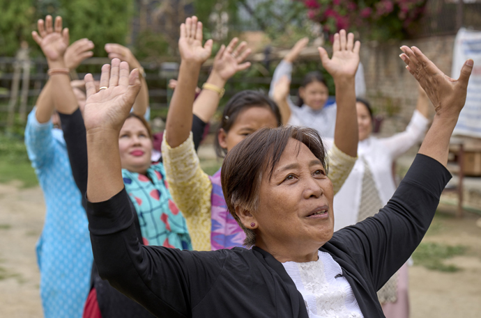 Emma Cantor uses Qigong movements to help women explore their power during an ecumenical seminar on women and leadership on May 24 at Hebron United Methodist Church in Lalitpur, Nepal. Cantor is a regional missionary for United Women in Faith. Photo by Paul Jeffrey, UM News.