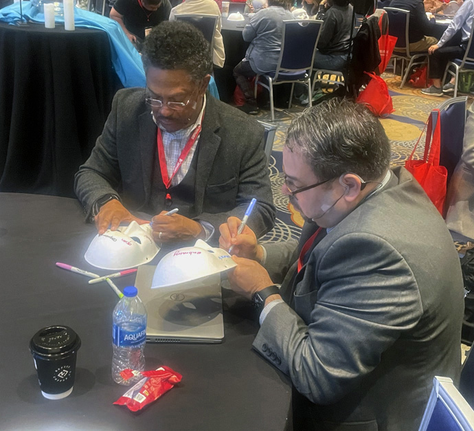 The Rev. Stephen Handy, pastor of McKendree United Methodist Church in Nashville, Tenn., and the Rev. Giovanni Arroyo, top executive of the United Methodist Commission on Religion and Race, take part in a “mask” exercise during the Facing the Future conference, held Nov. 14-16 in downtown Atlanta. Pastors from cross-cultural ministries decorated the outside of their mask to express the face they show to the outside world, while the inside of the mask reflected how they wish others would perceive them. Photo by Jim Patterson, UM News. 