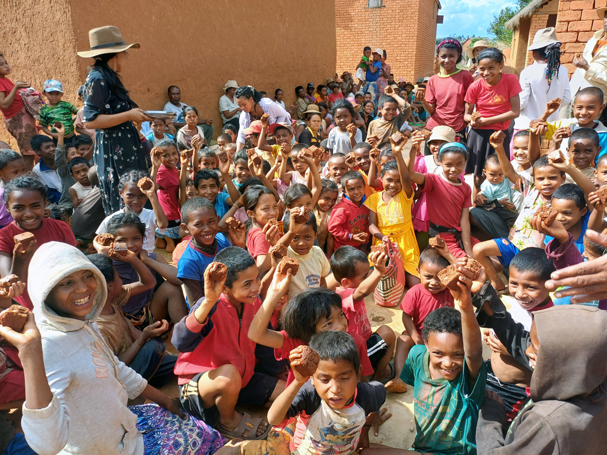 Children and youth show off the cake they received from visitors from Ambodifasika United Methodist Church in Faratanjona, Madagascar. The community faces food shortages due to climate change and other factors that have reduced crop production in the region. Photo by Esdras Rakotoarivony, UM News.