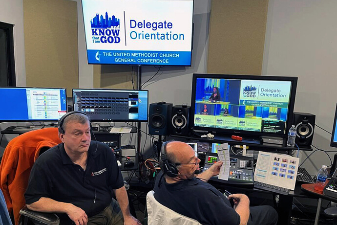 From left, Kirby Allen and Dan O’Connell provide production assistance to the online orientation co-hosted by United Methodist Communications and the Rev. Gary Graves, General Conference secretary. Just as with delegate orientation, many people help make General Conference possible. Photo by Tim Tanton, UM News.