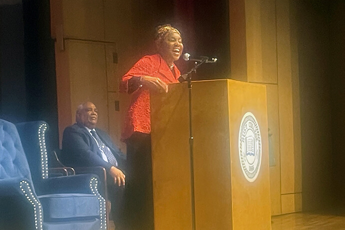 The Rev. Cynthia Davis (at podium), a retired district superintendent in the Mississippi Conference and executive vice president and director of The Moore-West Center for Applied Theology in Memphis, Tenn., speaks March 2, 2024, at Rust College in Holly Springs, Miss., as part of the Mississippi Conference’s End Racism for Good campaign. The Rev. Zachary Beasley (right), pastor of Asbury and Calvin Chapel United Methodist churches in Holly Springs, Miss., welcomed the public to the event and ended it with a benediction. Photo by Jim Patterson, UM News.