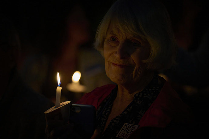 A candle holds hope as activists call on the denomination to greater stewardship of creation ahead of the 2024 United Methodist General Conference in Charlotte, N.C. A vigil and service took place at the First United Methodist Church of Charlotte. Photo by Paul Jeffrey, UM News.