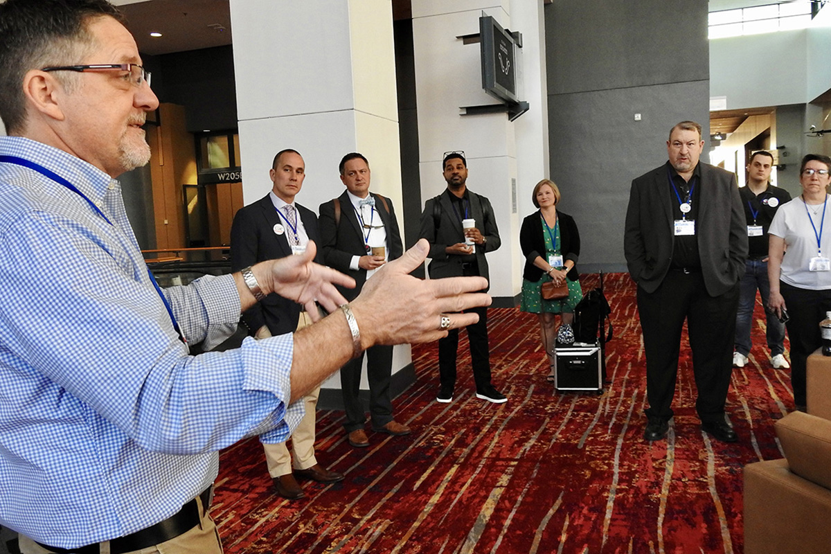 The Rev. Mark Holland (left) briefs on regionalization legislation during an April 25 morning meeting of Mainstream UMC at the Charlotte Convention Center. Mainstream UMC is among various groups seeking to influence legislation and advocate on behalf of causes during the United Methodist General Conference in Charlotte, N.C. Photo by Sam Hodges, UM News. 