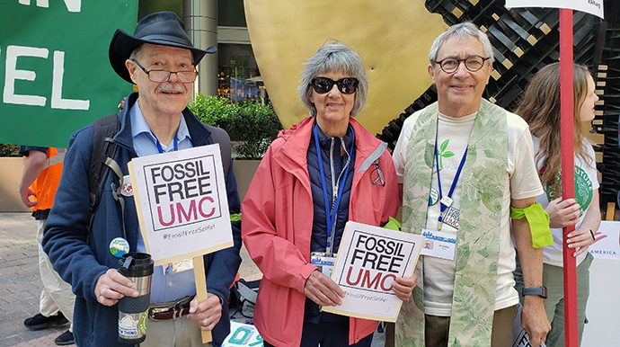 Jaydee Hanson (left), retired United Methodist Bishop Hope Morgan Ward and the Rev. Pat Watkins (right) take part in an April 23 demonstration at Bank of America headquarters in Charlotte, N.C. Fossil Free UMC joined in advocating for the bank to stop providing financial support to fossil fuel companies. The advocacy group also is hoping General Conference, meeting in Charlotte through May 3, will require United Methodist institutions to divest of fossil fuel company stocks. Photo courtesy of Fossil Free UMC.