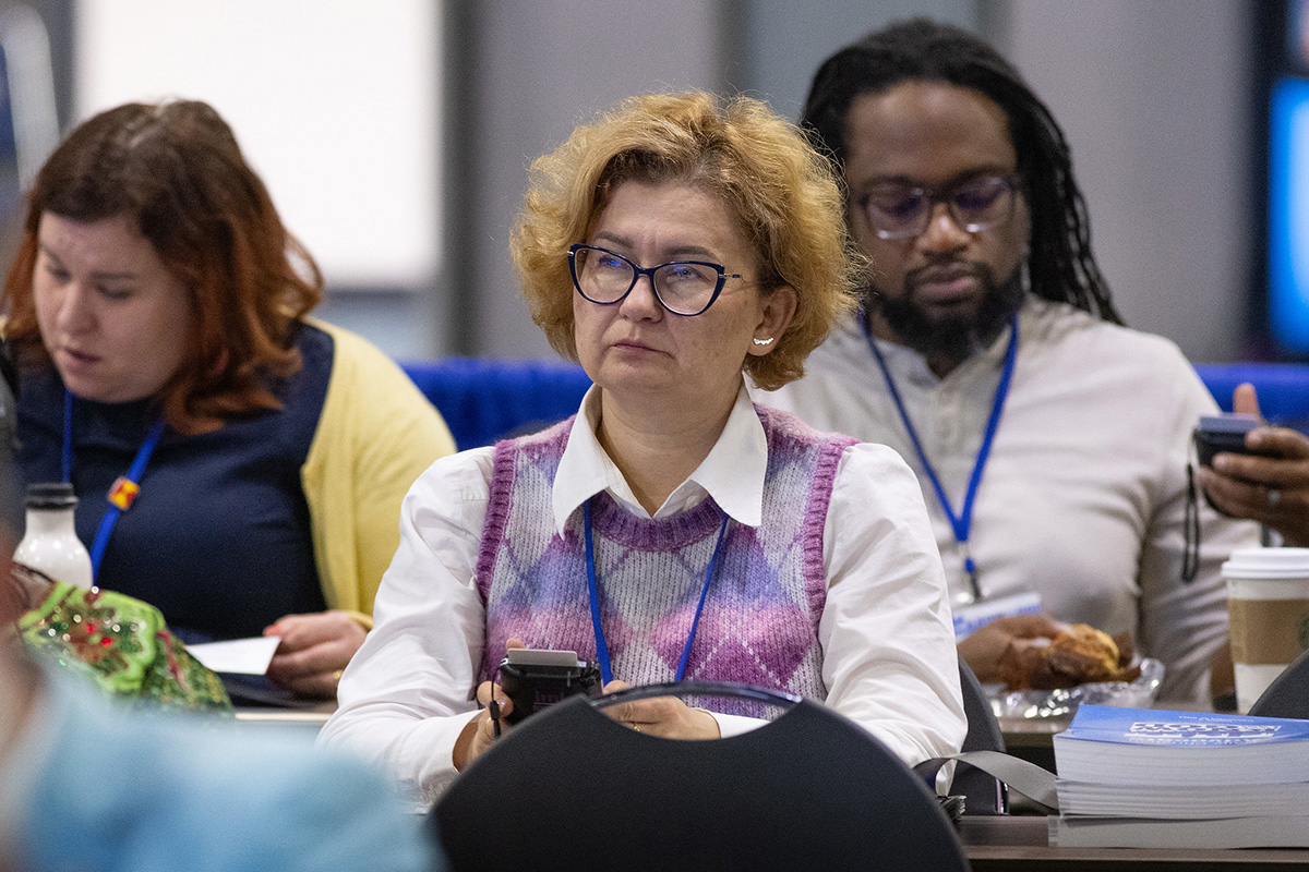 The Rev. Yulia Starodubets (center) votes on legislation during the United Methodist General Conference in Charlotte, N.C. Starodubets is a delegate for the Ukraine-Moldova Conference. Photo by Mike DuBose, UM News.