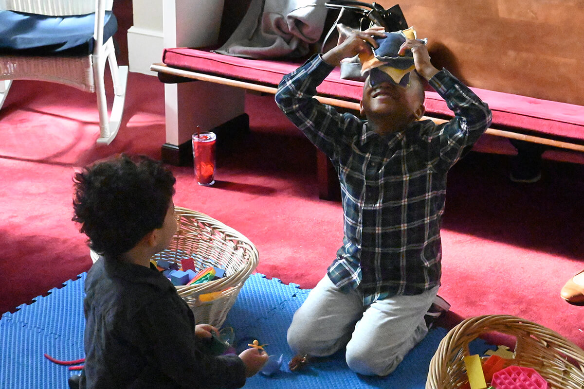 Children play before Sunday services begin on March 10 in the “prayground” of Bethany United Methodist Church in Smyrna, Ga. Church officials removed some pews at the front of the church to add the play area so parents could attend services while keeping watch on their kids. Photo by Jim Patterson, UM News.