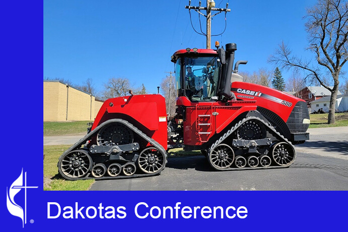 A tractor is parked in front of Arthur United Methodist Church in Arthur, N.D., for a Sunday worship service where seeds and equipment are blessed. Photo courtesy of Arthur United Methodist Church via the Dakotas Conference.