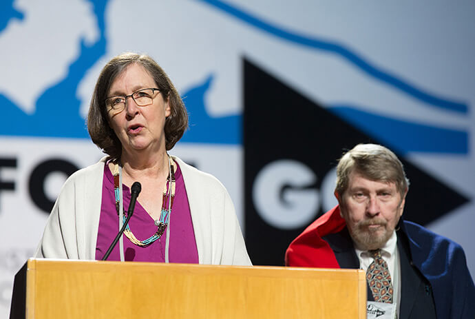 Bishop Elaine JW Stanovsky (left) introduces Gary L. Roberts, author of a report on the 1864 Sand Creek Massacre in which U.S. troops led by a Methodist preacher-turned-cavalry officer attacked unsuspecting Cheyenne and Arapaho Indians, killing more than 230 mostly women, children and elders. Roberts presented the report to the 2016 United Methodist General Conference and tribal representatives who were guests of the conference in Portland, Ore., on May 18, 2016. File photo by Mike DuBose, UM News.