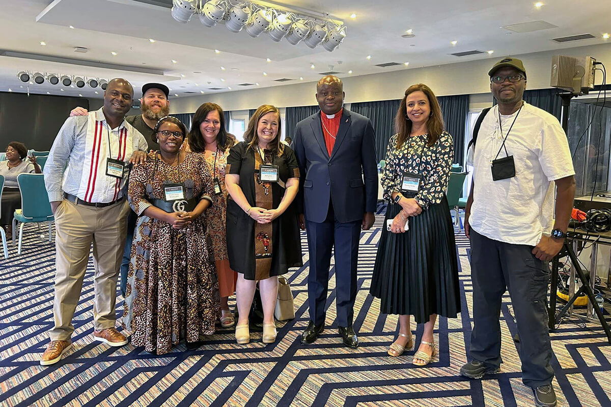 From left, Pacome Nguessan, Matt Crum, Priscilla Muzerengwa, Jennifer Rodia, Ashley Gish, North Katanga Area Bishop Mande Muyombo, Poonam Patodia and Chilima Karima celebrate together at the end of training on regionalization. All but the bishop work for United Methodist Communications. Photo courtesy of United Methodist Communications. 