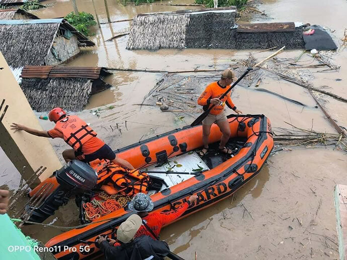Roofs of buildings show over floodwaters as Philippine Coast Guard personnel navigate a boat through debris during rescue operations in the Bicol region in the aftermath of Tropical Storm Trami. The Rev. Nonelio Talisic, superintendent of The United Methodist Church’s Central Bicol District, said that the people of Bicol “found themselves caught off guard by the silent but destructive arrival” of Trami. Photo courtesy of the Ako Bicol Online TV Facebook page.