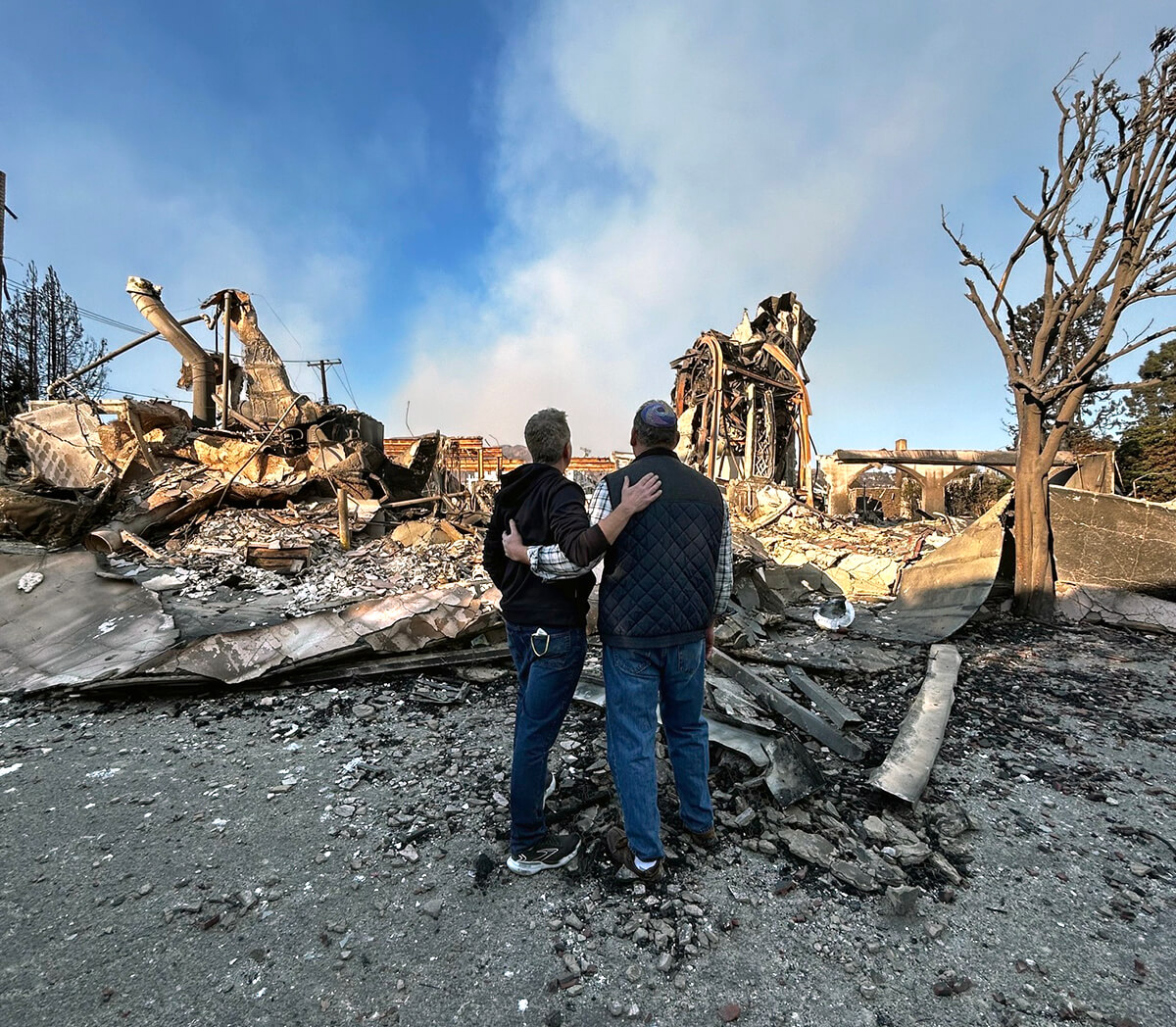The Rev. John Shaver (left) and his friend, Rabbi Mark Blazer, look out at the rubble left of Community United Methodist Church in Pacific Palisades, Calif., where Shaver is pastor. The community of Pacific Palisades was mostly destroyed by the Palisades wildfire. Photo courtesy of Shaver, California-Pacific Conference.