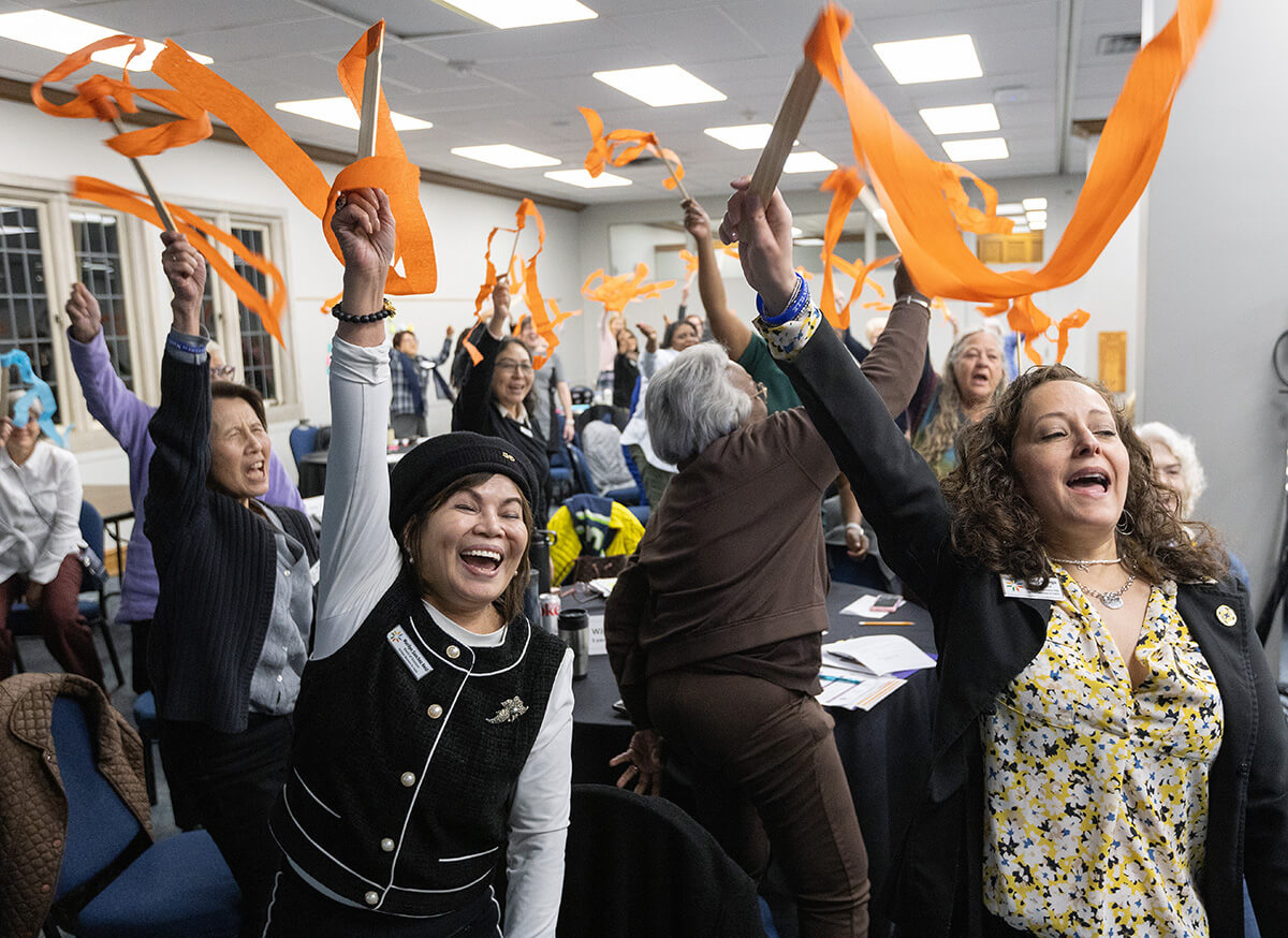 Members of the United Women in Faith Program Advisory Group celebrate the announcement of Assembly 2026, scheduled for May 15-17, 2026, in Indianapolis. Board and program advisory group members met in person March 6-9 at Scarritt Bennett Center in Nashville, Tenn., the organization’s first in-person meeting since early 2020. Pictured in the foreground are board member Marilyn Sanchez Reid of the Western Jurisdiction and Vice President Heidi Careaga of the North Central Jurisdiction. Photo by Mike DuBose, UM News. 