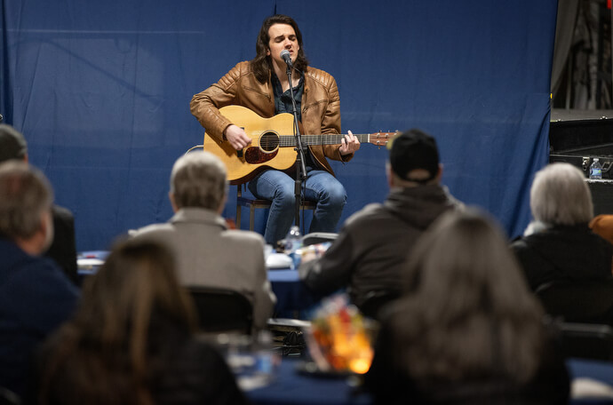 Musician Bay Simpson performs one of his songs during Crafted Conversations at the Singin’ River Brewing Co. The monthly series features a musical guest who helps spark conversations on a range of topics such as kindness, honesty and connection.