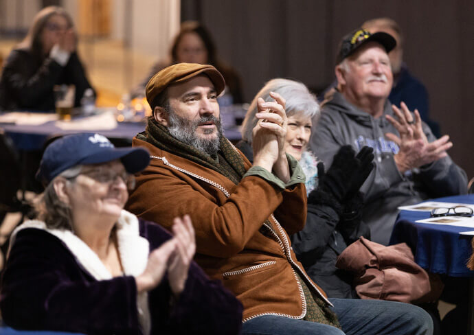 Participants applaud musician Bay Simpson during Crafted Conversations.