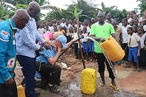 Susie and Ed Keefer pose with Miriam, age 4, in Kinshasa, Congo, in 2013. Shortly afterward, Miriam went home with the Keefers to the United States. The matching outfits were a gift from Dr. Rebecca Yohadi. Photo courtesy of Susie Keefer.