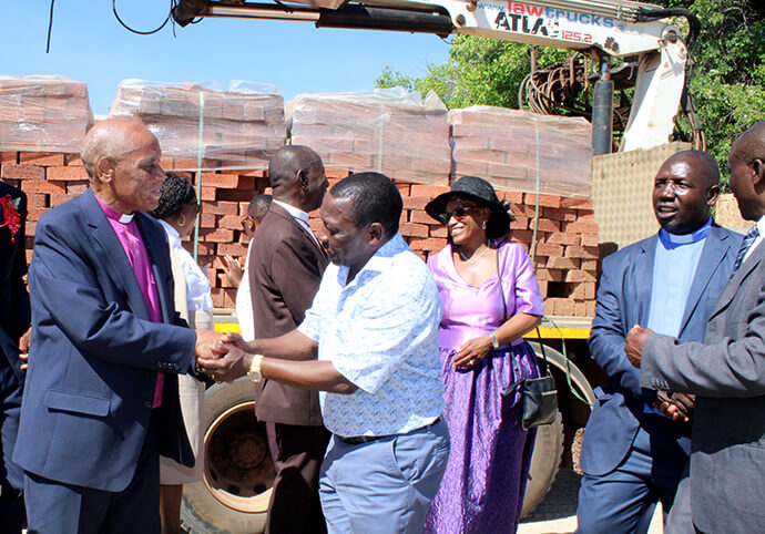 Bishop Eben K.  Nhiwatiwa thanks Ray Kaukonde for the donation of 40,000 bricks that will be used for the construction of Chikwizo United Methodist Church. Photo by Kudzai Chingwe, UM News.
