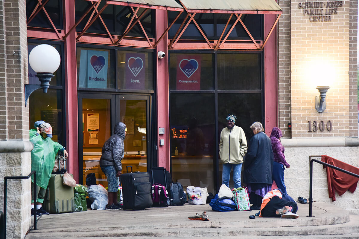 Unhoused women wait for the doors to open on the morning of March 28 at First United Methodist Church of Austin, Texas. Each Friday, the women are able to get showers, pick out new clothing from donations the church has collected, have a meal or enjoy the luxury of sleeping in a safe environment. Once a month, they can get their hair washed, cut and styled. Photo by Andrea Turner, UM News.