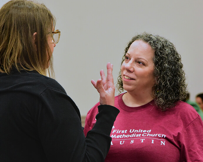 The Rev. Cathy Stone (right), associate pastor of First United Methodist Church of Austin, chats with a volunteer March 28 at the church. Stone is the driving force behind the church’s efforts to cater to the needs of unhoused people. Each Friday, volunteers provide women with food and pampering. Photo by Andrea Turner, UM News.