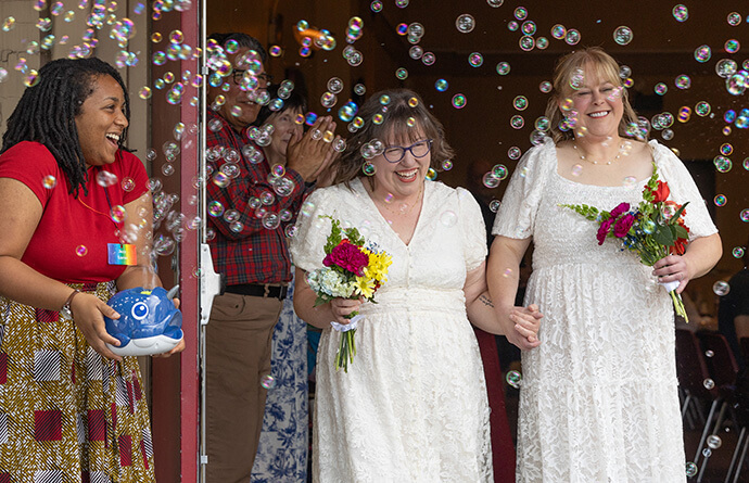 Lindsey Dye (center) and Laura Smotherman are showered with bubbles after they renewed their wedding vows at Edgehill United Methodist Church in Nashville, Tenn. Photo by Mike DuBose, UM News.