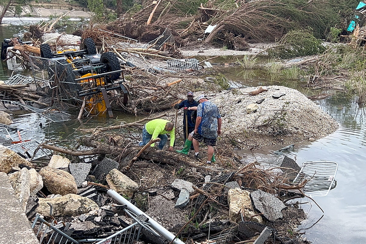 Trabajadores buscan el 6 de julio entre los escombros en el Parque Louise Hays en Kerrville, Tejas después de que inundaciones catastróficas durante el fin de semana del 4 de Julio mataran al menos a 95 personas, incluidos/as 27 campistas y consejeros/as en el cercano Campamento Místico. Foto de la Revda. Amanda Banda, Conferencia Anual de Rio Tejas.