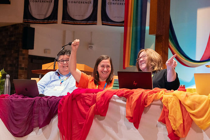 From left, Recconciling Ministries Network staff members Helen Ryde, the Rev. Emily Bagwell and Laura Young delight in sharing the state of the movement for LGBTQ inclusion. For the first time, United Methodists policies do not ban gay ordination or same-sex weddings denomination-wide. Photo by Joscie Cutchens, UM News.   
