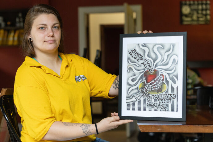 Destiny Varner displays artwork she created to help promote the Deep Time ministry in Asheville, N.C.