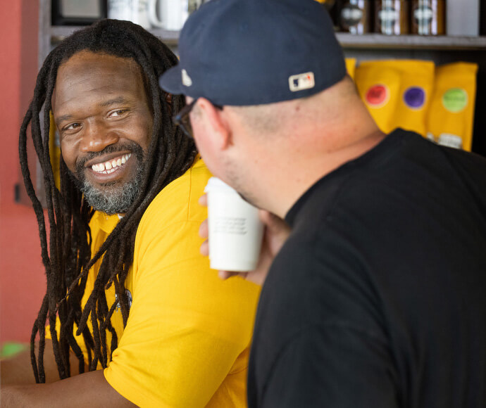 Timothy "GA" Underwood (left) and the Rev. Dustin Mailman share conversation and smiles at Deep Time. The ministry uses the connecting power of a good cup of coffee to help create engagement with people impacted by incarceration.