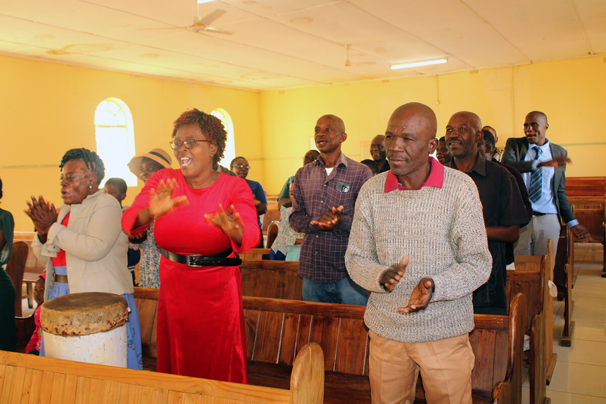 Members sing during Morning Service in the Nyanyadzi Circuit of Zimbabwe. The special 7 a.m. worship service welcomes struggling community members and walks with them through their journey of recovery and faith. Photo by Kudzai Chingwe, UM News. 