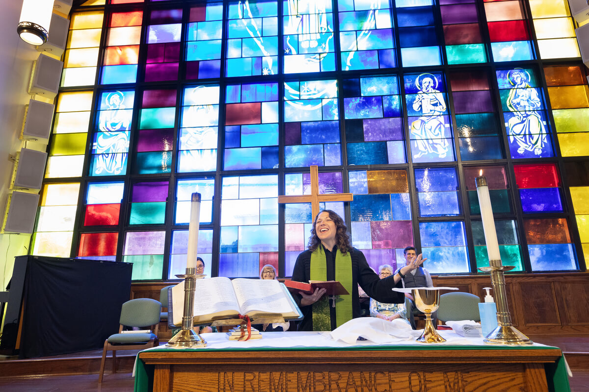 The Rev. Colleen Bookter blesses the elements of Holy Communion during worship at St. Luke’s United Methodist Church. Photo by Mike DuBose, UM News.