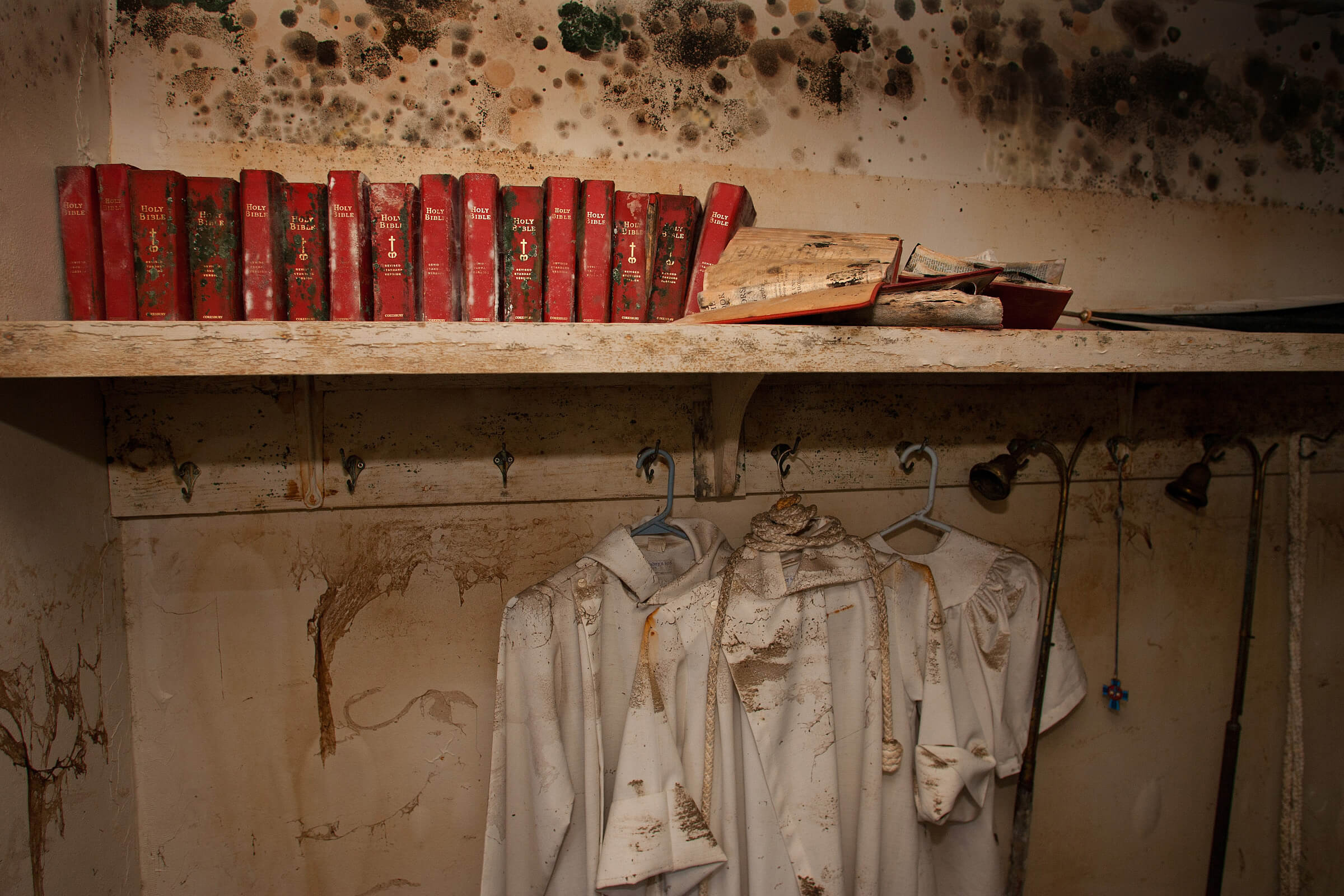 Mold covers the walls, Bibles and acolyte robes in the sacristy at St. Luke’s United Methodist Church following Hurricane Katrina. Photo by Mike DuBose, UM News.