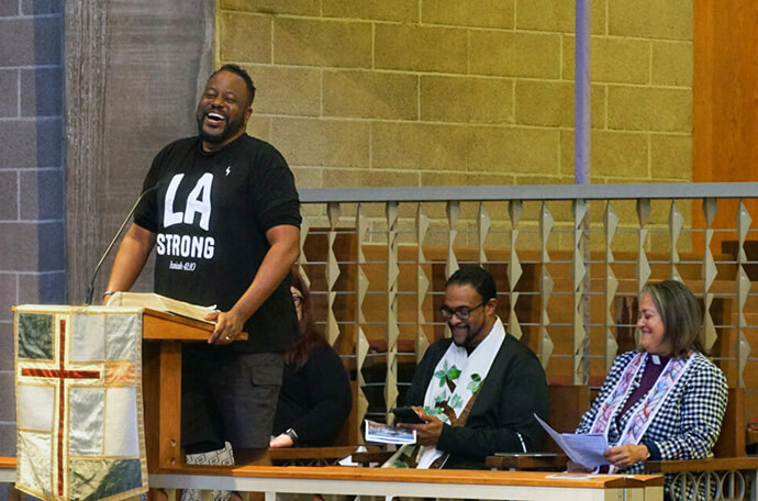 The Rev. J. Andre Wilson shares Altadena United Methodist Church’s account of disaster, hope and emerging recovery from the January wildfires during a North District gathering May 31 at Glendale United Methodist Church in Glendale, Calif. The daylong event drew about 150 people to raise support for the church and to honor district confirmands. Seated next to Wilson are (from left) the Rev. Garth Gilliam, North District superintendent, and California-Pacific Conference Bishop Dottie Escobedo-Frank. Photo courtesy of Alyssa Fisher.