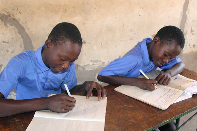 Tafaranashe Musekiwa (left) and Ralph Tsumbe do their schoolwork while attending classes at Dindi Mission in Mutawatawa, Zimbabwe. The mission was established in 1938 by a Methodist missionary. Photo by Kudzai Chingwe, UM News.